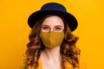 smiling-woman-face-mask-deagreez-adobestock_345665996